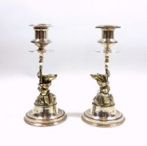 Pair of novelty silver candlesticks, each modelled as a gnome or dwarf holding the urn shaped
