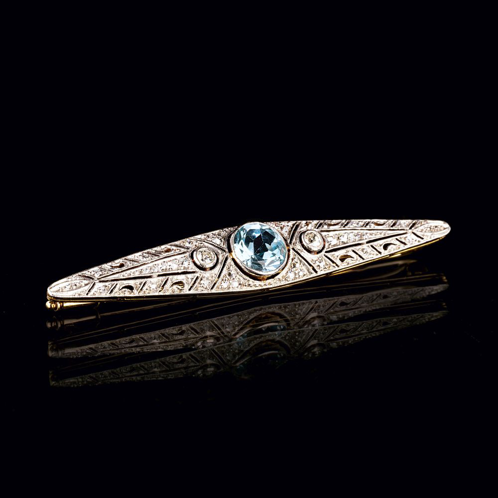 An Art-déco Blue Topaz Brooch with Diamonds.