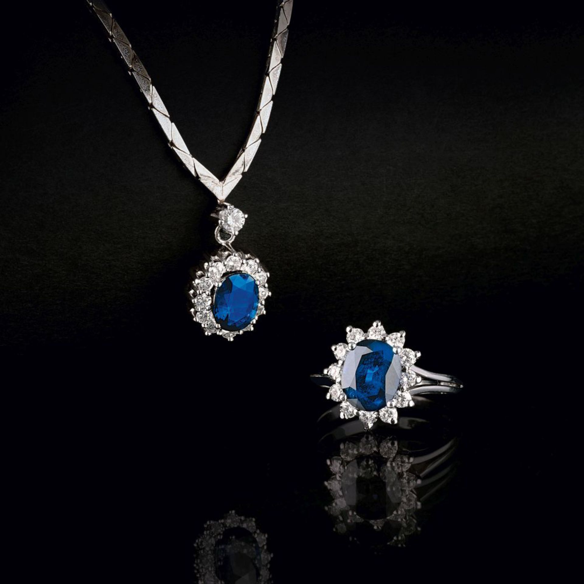 A Sapphire Diamond Ring with matching Pendant on Necklace.