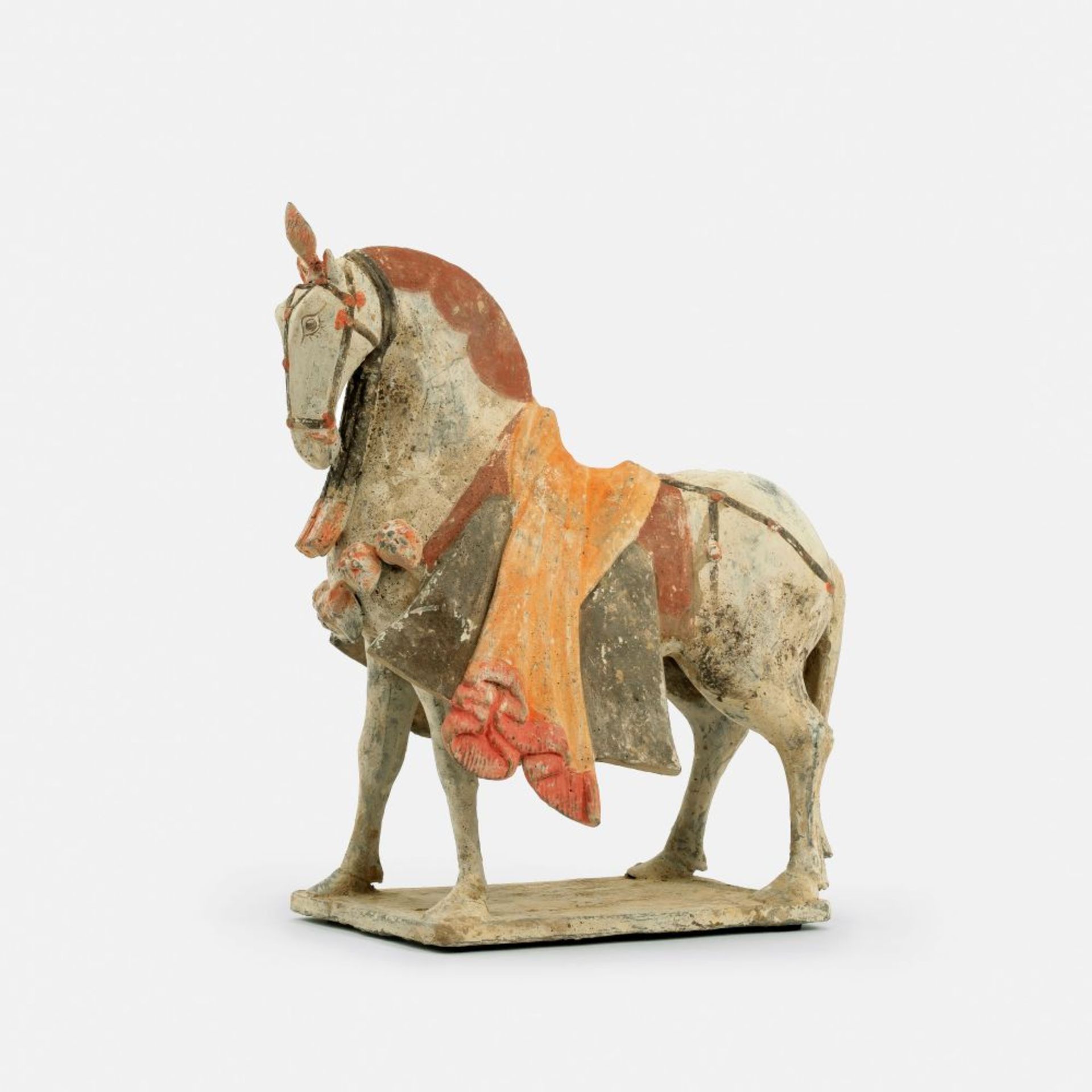 A Painted Pottery Figure of a Caparisoned Horse.