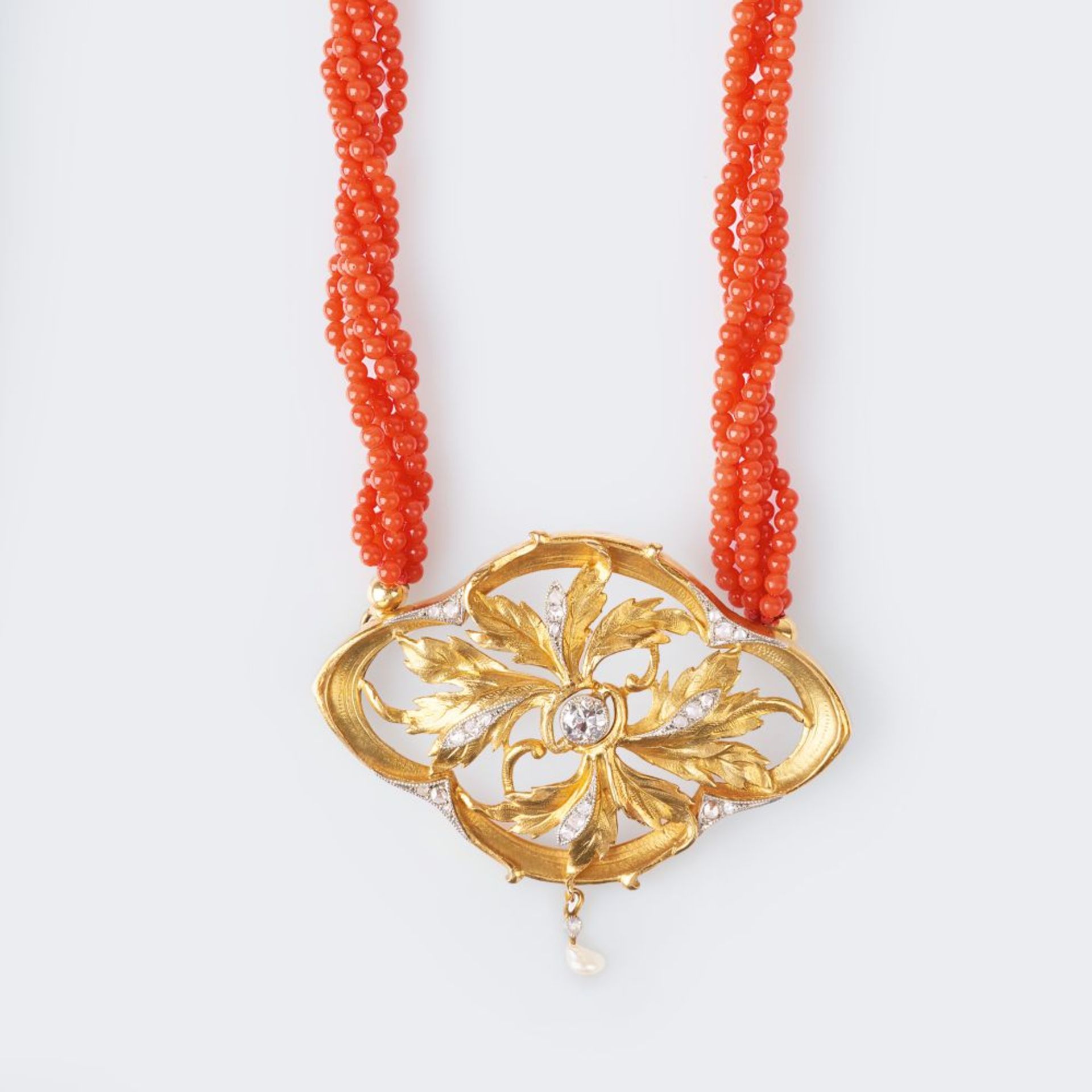 An Art-Nouveau Diamond Pendant on Coral Necklace.