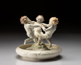 A HUTSCHENREUTHER SELB PORCELAIN 'DANCING CHERUBS' FIGURAL GROUP AND BOWL