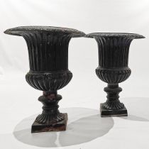 A PAIR OF BLACK-PAINTED CAST-IRON GARDEN URNS