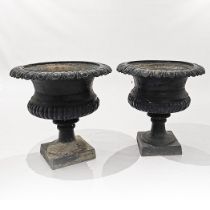 A PAIR OF BLACK-PAINTED CAST-IRON GARDEN URNS
