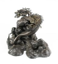 A JAPANESE PATINATED BRONZE OF A WINGED DRAGON, MEIJI PERIOD, 1868 - 1912