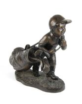 A BRONZE FIGURE OF A GOLFER AND HIS CLUBS