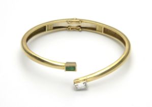 AN EMERALD AND DIAMOND BANGLE, CIRCA 1970