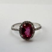 fine 18 CT white gold rubelite and diamond Halo ring. Fully hallmarked for 18 CT gold. set with