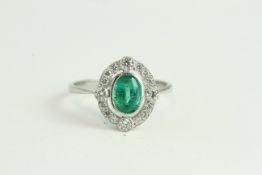 Platinum Oval Bezel-set Emerald Inside Open Halo of Diamonds with 4 Focal Points Slightly Raised. No