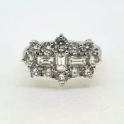 A diamond ‘Boat’ ring, three central baguette diamonds inside a surround of brilliant cut diamonds