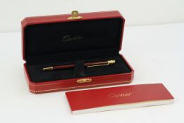 CARTIER BALLPOINT WITH BOX AND PAPERS, red lacquer case, gold detail, with Cartier box and paperwork