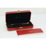 CARTIER BALLPOINT WITH BOX AND PAPERS, red lacquer case, gold detail, with Cartier box and paperwork