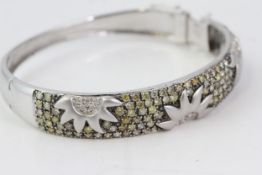 Fine 18 CT white gold fancy champagne yellow diamond bangle. Marked 750/18 K. Set with brilliant cut