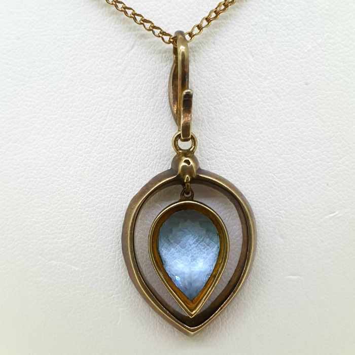 A vintage yellow gold bezel set pear shaped aquamarine and diamond pendant, suspended on a diamond - Image 2 of 4