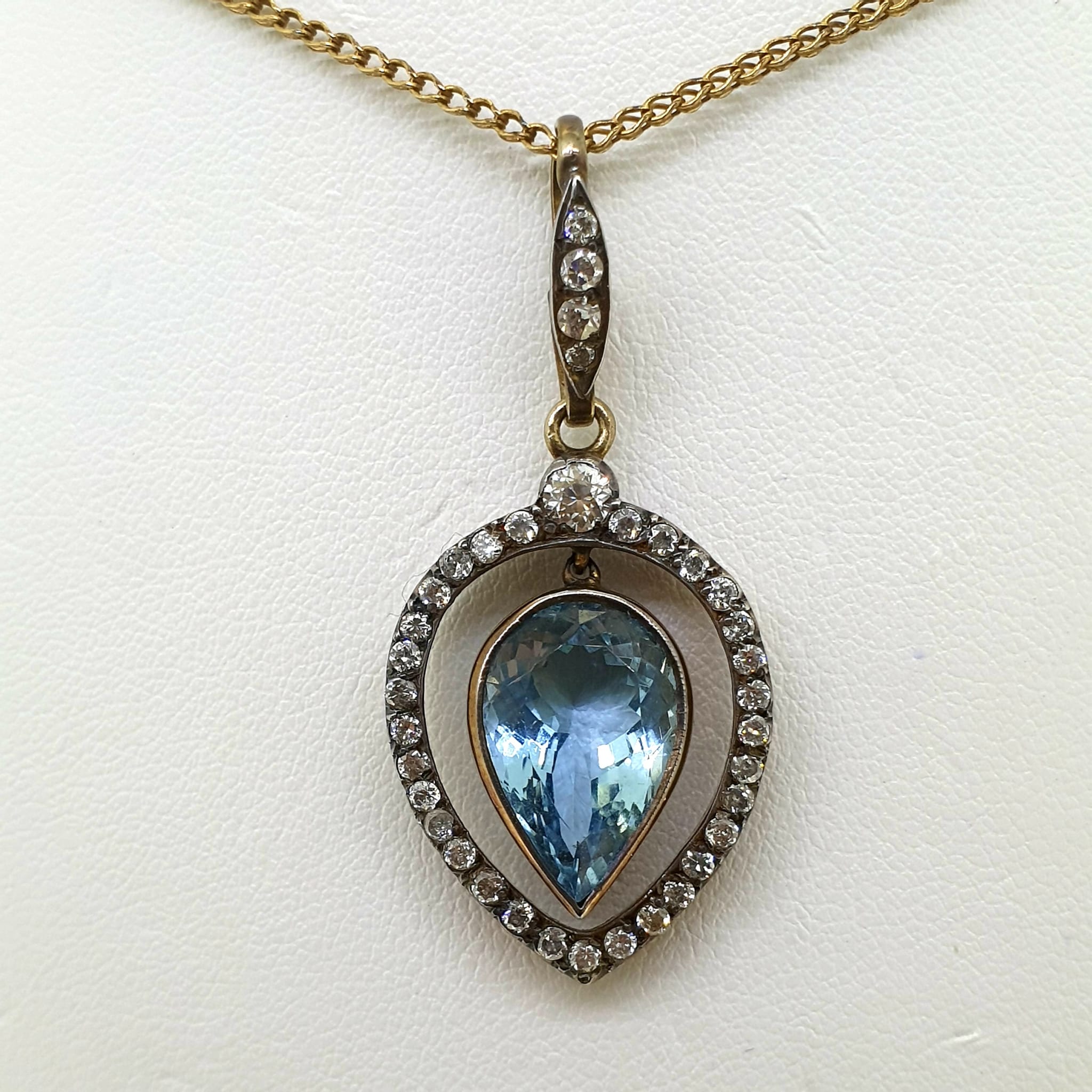 A vintage yellow gold bezel set pear shaped aquamarine and diamond pendant, suspended on a diamond - Image 4 of 4