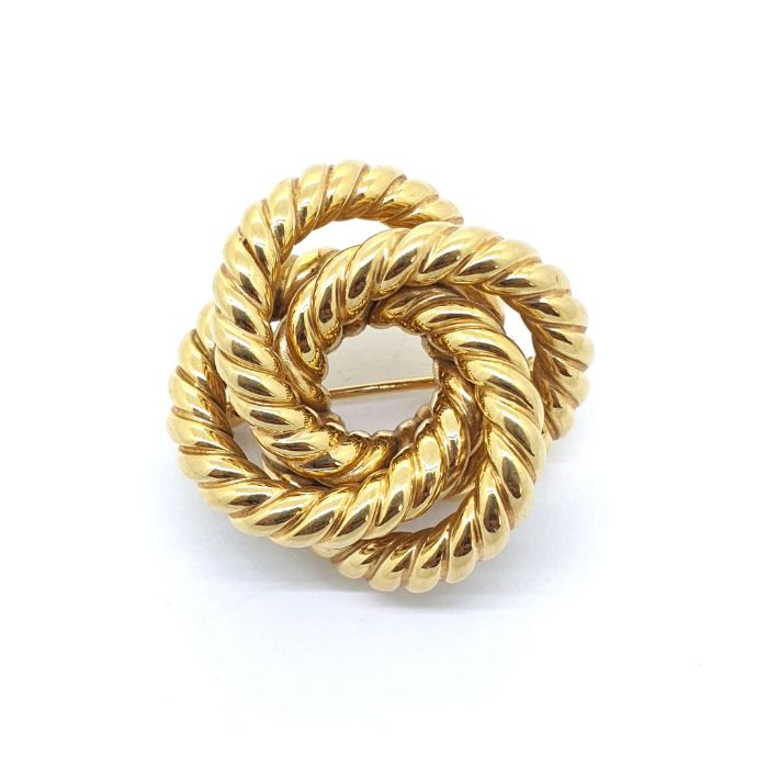 In yellow gold a lovers knot, the clasp is marked 14K and there is a faint ‘Tiffany’ mark on the