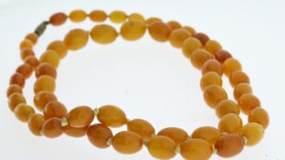 Antique butterscotch bead necklace. The beads weigh 30.4 grams . Measures 30 inches in length and th