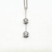 18WG double diamond drop pendant suspended on a 9WG chain 16 inches