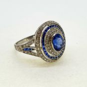 Platinum oval sapphire and diamond target ring with split sapphire and diamond shoulders. Marked