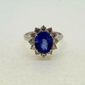 Oval sapphire and diamond cluster ring in 18 carat white gold. Sapphire 3.20 carats, 12 diamonds