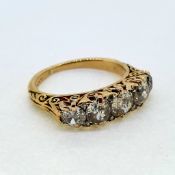 In 18 carat yellow gold a victorian carved 5 stone ring. The diamonds are estimated to weigh 2.50