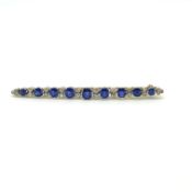 An Antique brooch pin comprising 9 graduating sapphires separated by 22 old cut diamonds. Length 7cm