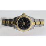 LADIES ROLEX OYSTER PERPETUAL REFERENCE 76193, black dial with gold baton hour markers, fluted