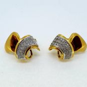 Yellow gold and diamond clip on earrings, circa 1940. The diamonds are set in a three row taper in