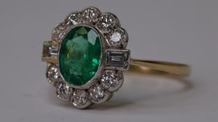 18WG & YG EMERALD & DIAMOND RING, Central oval bezel set emerald surrounded by brilliant cut