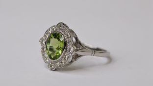 PLATINUM OVAL PERIDOT & DIAMOND RING, highlighted focal points P1.35 D0.30