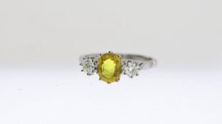 Yellow Sapphire and Diamond Three Stone Ring, oval cut yellow sapphire mounted between two round cut
