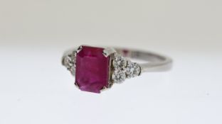 Ruby and Diamond ring, rectangular cut ruby with a trefoil of brilliant cut diamonds to each