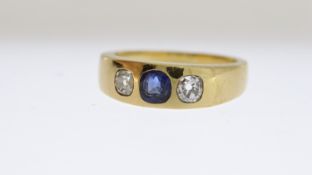 18ct Sapphire and Diamond Band, central sapphire mounted with a diamond to each shoulder, gypsy set,