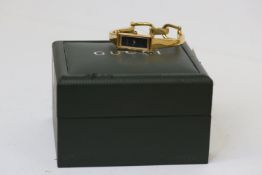 LADIES GUCCI QUARTZ WATCH 1500L WITH BOX, rectangular black dial, gold plated bangle watch, quartz
