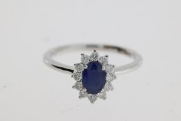 An oval sapphire and diamond ring. Sapphire 0.56 carats, diamonds total 0.22 carats 18 carat white