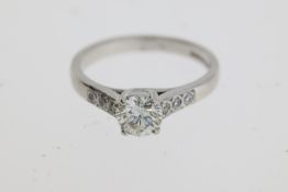 A Birmingham hallmark for 18 carat gold is stamped inside this diamond solitaire ring. The round