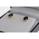 Pair of 18k yellow gold studs set with treated sapphires and diamonds, boxed. Oval sapphires 3.00ct.