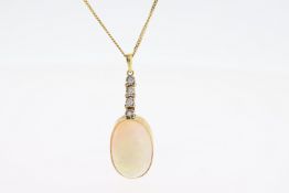 An oval Cabochon Opal sits in a gold settingbelow below 4 round diamonds suspended froma 16 inch