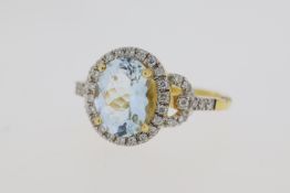 18 carat yellow gold oval aquamarine and diamond ring with diamond lock shoulders. Weights A2.30