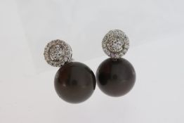 18 carat white gold diamond cluster studs with 13mm dark pearls suspended. Weights D 0.62