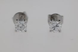 18 carat white gold 4 claw diamond set earrings. Weights D 0.48