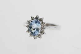 18ct white gold oval aquamarine and RBC diamond cluster ring. Aqua 0.80ct. Diamonds 0.30ct