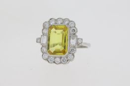 Platinum yellow sapphire and diamond dress ring with a baguette highlight at the shoulder tip.