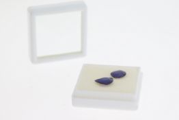 Parcel of two loose, unmounted treated/glas filled sapphires, one pear shaped and the other oval,