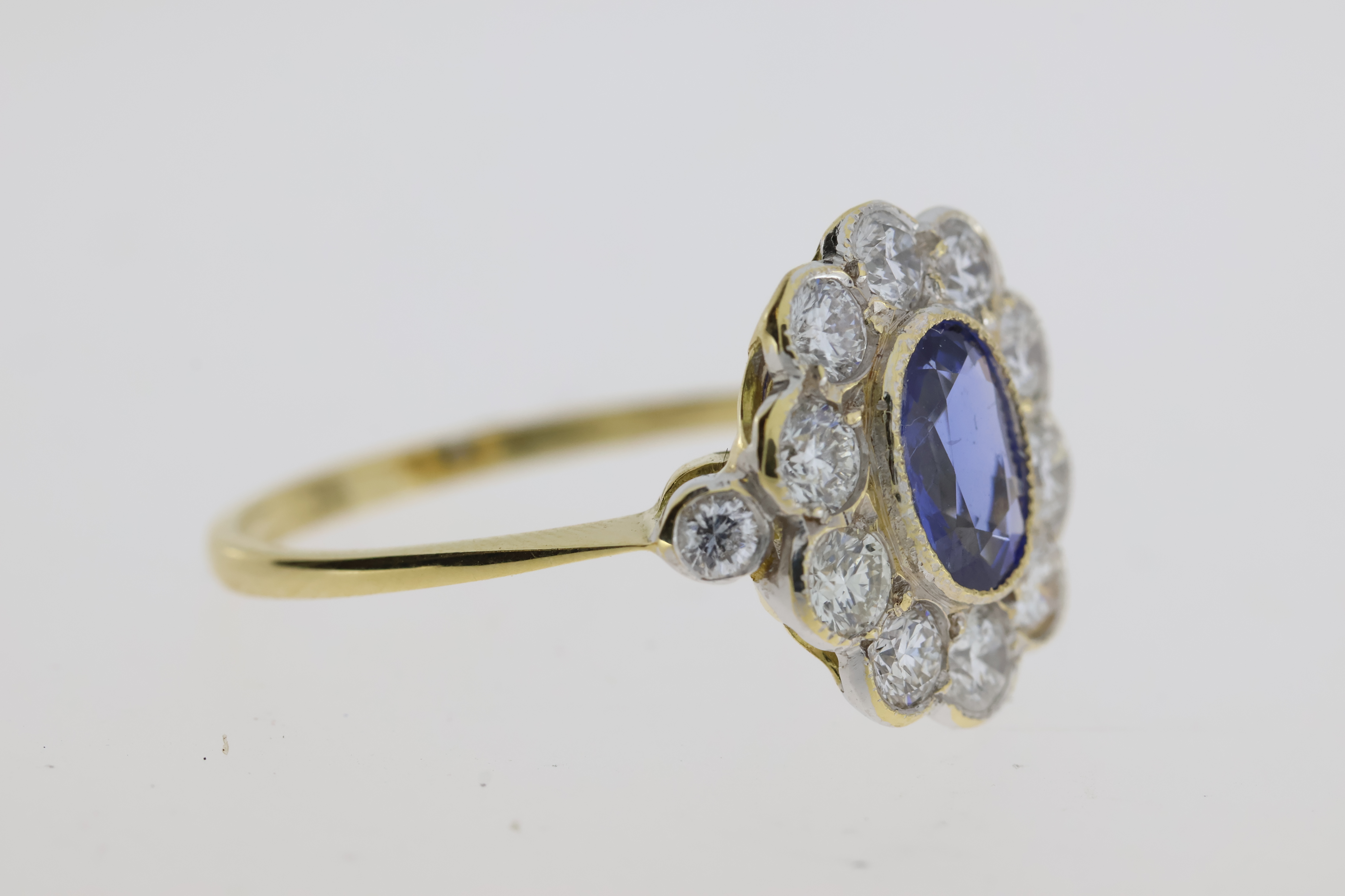 18YG oval sapphire and diamond cluster ring bezel set with a diamond at each shoulder S1ct D0.98 - Image 4 of 5