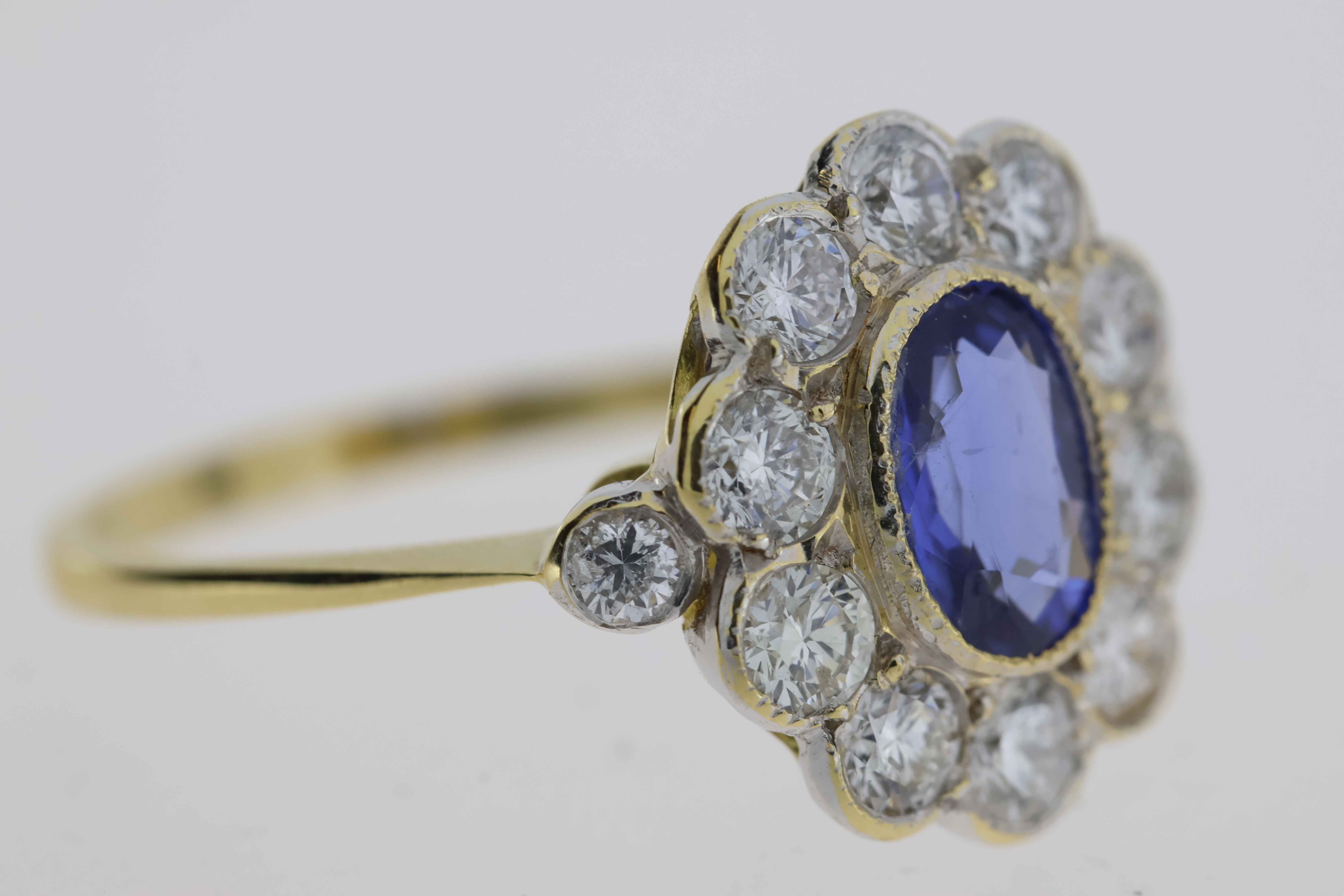 18YG oval sapphire and diamond cluster ring bezel set with a diamond at each shoulder S1ct D0.98 - Image 3 of 5