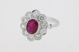 18 carat white gold oval bezel set ruby and diamond cluster ring Weights R1.30 D1.0