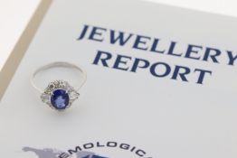 Certificated 18ct white gold set with a central oval-cut sapphire and RBC and tapered baguette-cut