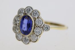 18YG oval sapphire and diamond cluster ring bezel set with a diamond at each shoulder S1ct D0.98