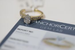 18ct yellow gold pear cut diamond solitaire ring in a white gold setting with channel set diamond